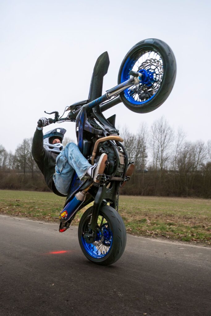 Supermoto-Fahrer beim Wheelie-Stunt